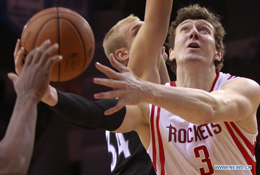 Omer Asik (R) of Houston Rockets competes during the NBA basketball game against Minnesota Timberwolves in Houston, the United States, on March 15, 2013. 