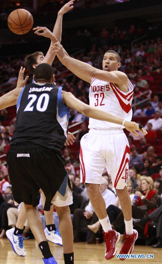 Francisco Garcia (R) of Houston Rockets passes the ball during the NBA basketball game against Minnesota Timberwolves in Houston, the United States, on March 15, 2013.