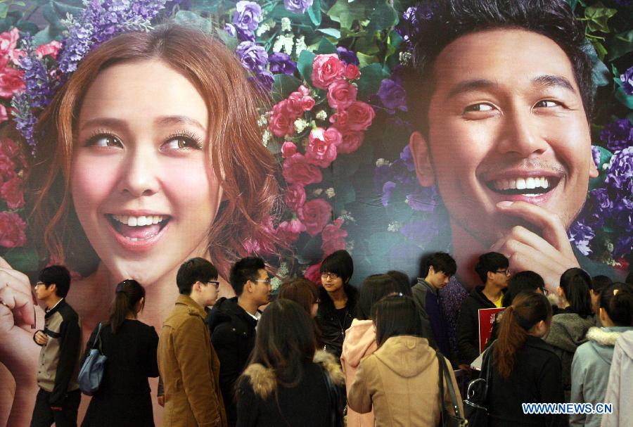 Visitors consult exhibitors about wedding services information during the 2013 Xici Wedding Expo for Spring in Nanjing, capital of east China's Jiangsu Province, March 16, 2013.