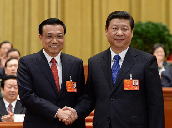 Xi Jinping (R) shakes hands with Li Keqiang at the fifth plenary meeting of the first session of the 12th National People's Congress (NPC) at the Great Hall of the People in Beijing, capital of China, March 15, 2013. Li Keqiang was endorsed as the premier of China's State Council at the meeting here on Friday. [Xinhua/Ma Zhancheng]