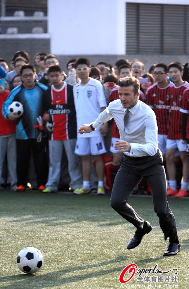 David Beckham plays football with students of Beijing No. 2 High School in Beijing on March 20, 2013.