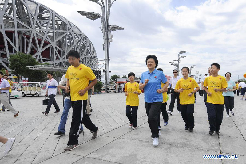 Chinese State Councilor Liu Yandong takes part in a long distance run in Beijing on June 10, 2012. 