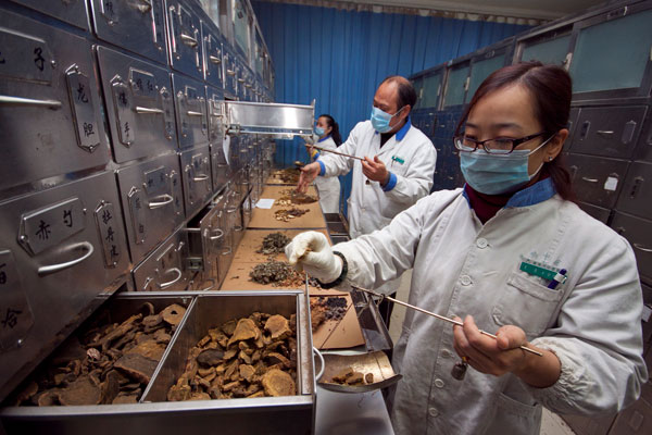 Workers prepare medicines at a traditional Chinese medicine hospital in Xiangyang, Hubei province.