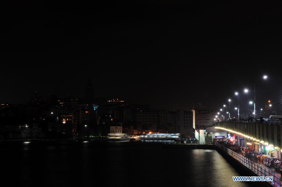 The Galata Tower turns off the lights to mark the annual &apos;Earth Hour&apos; event in Istanbul of Turkey on March 23, 2013. (Xinhua/Ma Yan)