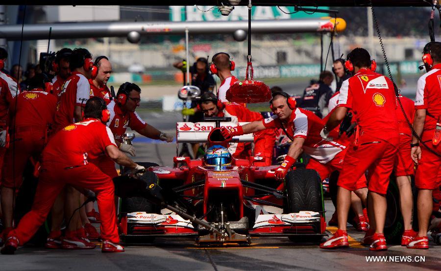 Ferrari driver Fernando Alonso of Spain drives out of the pit during the qualifying session for the Malaysian F1 Grand Prix at Sepang International Circuit outside Kuala Lumpur, Malaysia, March 23, 2013. (Xinhua/Zhang Wenzong)