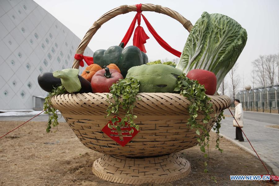 A giant sculpture of a vegetable basket is seen during the 1st Agriculture Carnival at the Strawberry Expo Park in Changping District, Beijing, capital of China, March 23, 2013. Opened Saturday, the carnival will continue till May 12, highlighting the latest agricultural science, technologies and creative agricultural projects. (Xinhua/Li Xin)