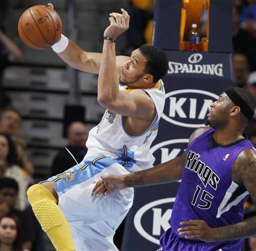  Denver Nuggets forward JaVale McGee pulls in a rebound in front of Sacramento Kings center DeMarcus Cousins in the first quarter of an NBA basketball game in Denver on Saturday, March 23, 2013.