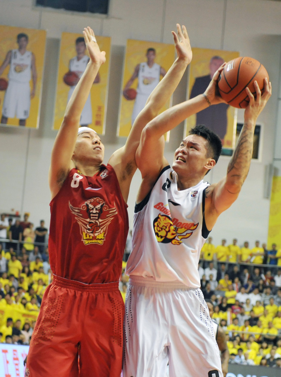 Zhu Fangyu of Guangdong goes up for a basket against Li Jingyu of Shandong in Game 2 of CBA Finals on March 24, 2013. 