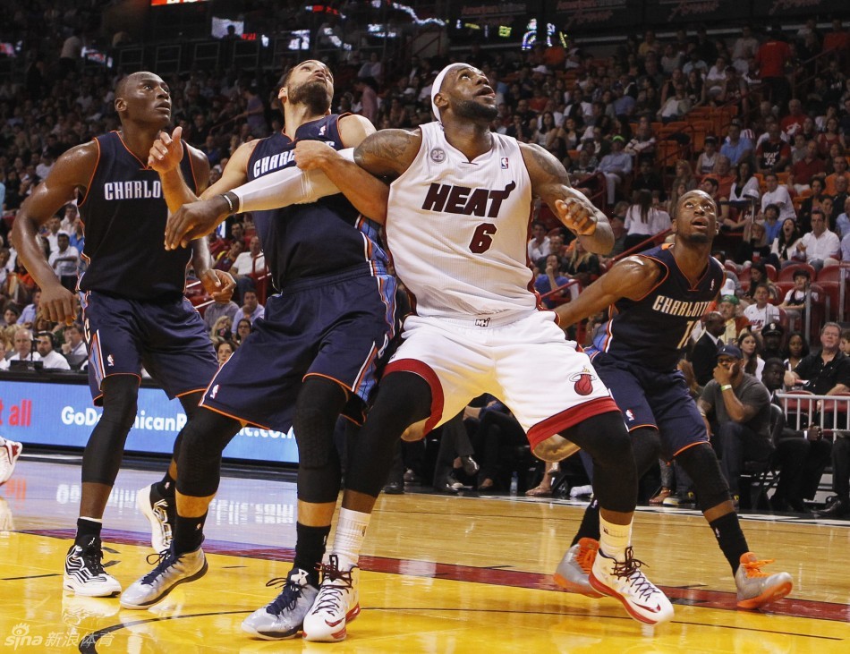 LeBron James and Gerald Henderson position for a rebound in a NBA game between Charlotte Bobcats and Miami Heat on March 24, 2013. 