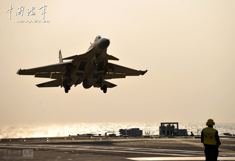 A PLA Navy's J-15 jet fighter practises take-off and landing on the country's first aircraft carrier, the Liaoning. [Photo / Navy.81.cn]