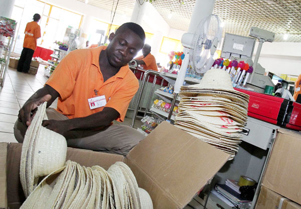 A salesman checks goods at a Chinese supermarket in Brazzaville, capital of Republic of the Congo. [Meng Chenguang / Xinhua]