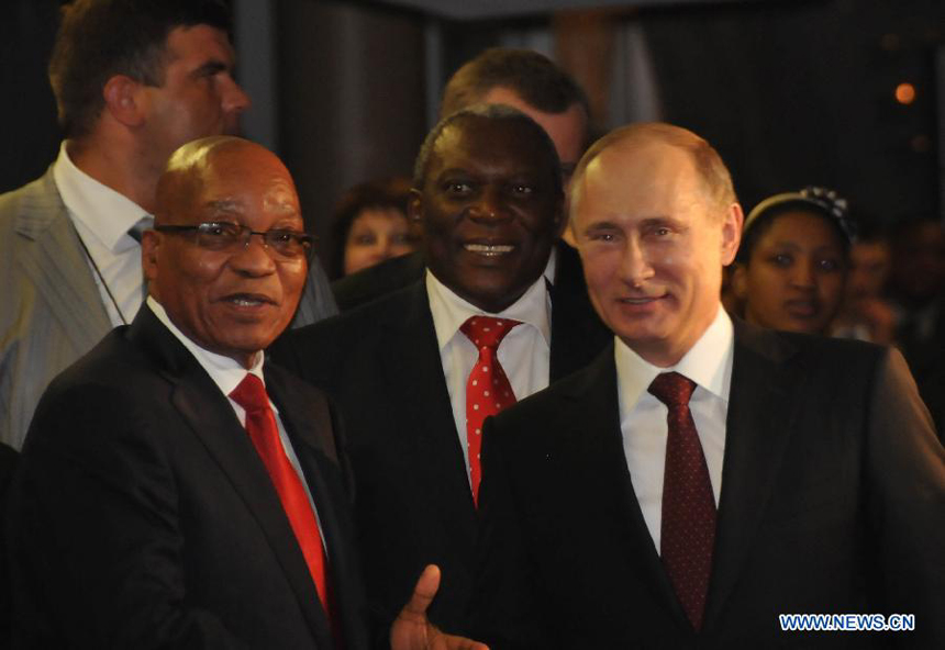 South African President Jacob Zuma(L) greets Russian President Vladimir Putin(R) upon his arrival at International Convention Centre (ICC) in Durban, southeastern port city of South Africa on March 26, 2013. South Africa will host the Fifth BRICS Summit from March 26 to 27, 2013, at the Durban International Convention Center (ICC). 