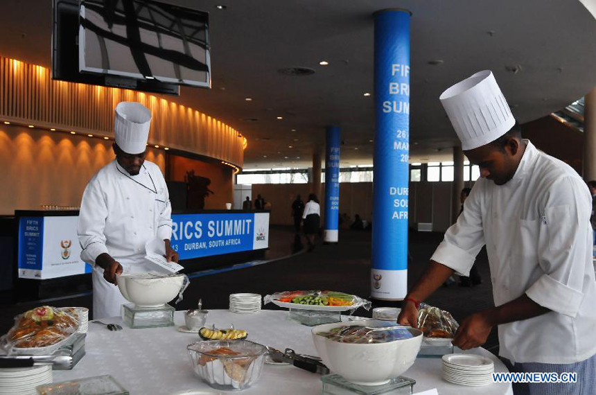 Two chefs prepare lunch for delegates at the International Convention Centre (ICC) in South Africa&apos;s port city of Durban, March 26, 2013. South Africa will host the fifth BRICS Summit from March 26 to 27, 2013, at the Durban International Convention Center (ICC). 
