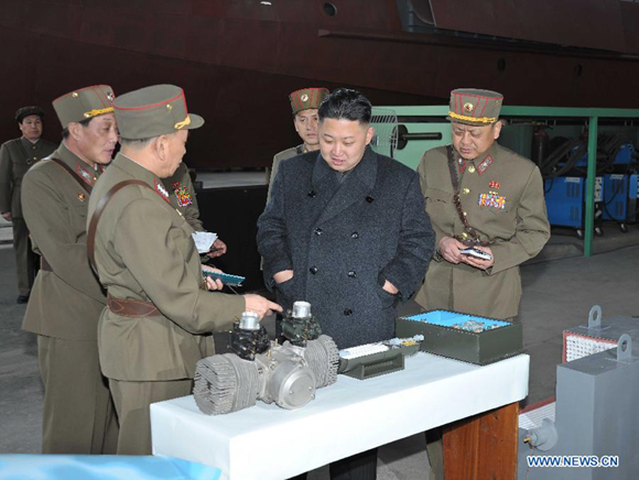 Photo provided by Korean Central News Agency (KCNA) on March 25, 2013 shows Kim Jong Un (C), top leader of the Democratic People's Republic of Korea (DPRK), inspecting People's Army Unit 1501.