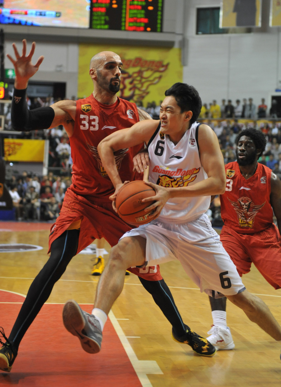 Chen Jianghua of Guangdong goes up for a basket against Zaid Abbas of Shandong in Game 3 of CBA Finals on March 27, 2013. 