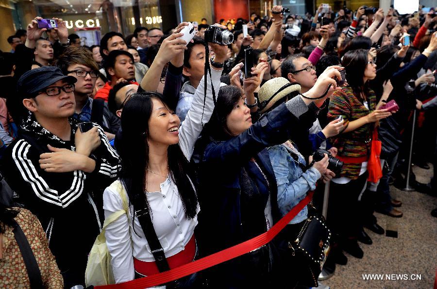 Fans take pictures at an exhibition for paying tribute to Cheung in Hong Kong, south China, March 30, 2013. The exhibition is held to mark the 10th anniversary of the death of Leslie Cheung, who leapt to his death from a hotel in Hong Kong on April 1, 2003. 