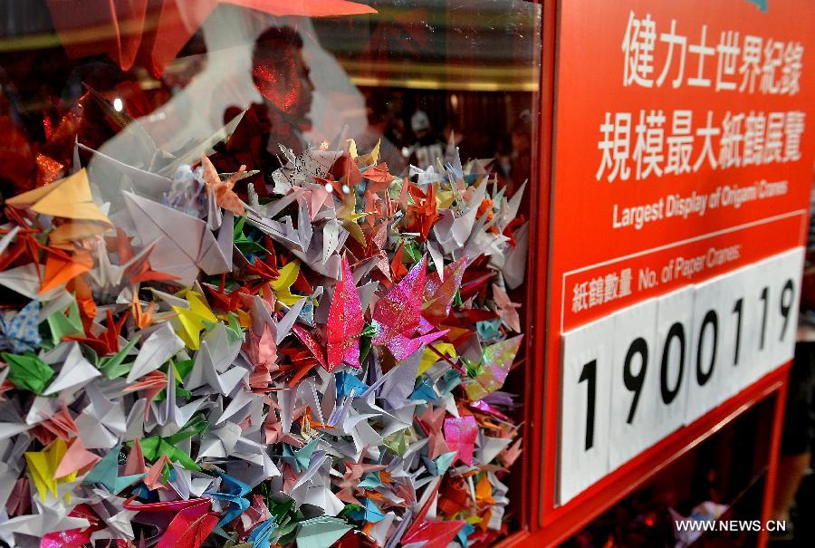 A total of 1,900,119 origami cranes, folded by fans around the world, are displayed inside a giant red cube at an exhibition for paying tribute to late Hong Kong actor Leslie Cheung in Hong Kong, south China, March 30, 2013. The exhibition is held to mark the 10th anniversary of the death of Leslie Cheung, who leapt to his death from a hotel in Hong Kong on April 1, 2003. 