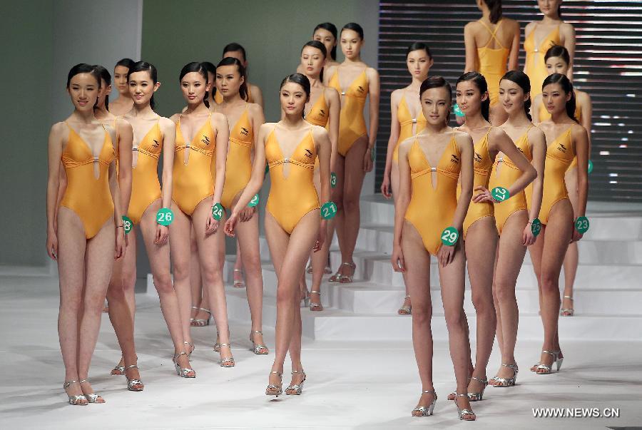 Contestants present swimsuits during the 8th China Super Model Final Contest in Beijing, capital of China, March 30, 2013. [Wan Xiang/Xinhua]