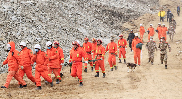 Rescuers on their way to retrieve bodies of workers buried in a landslide at the Jiama mining area in Maizhokunggar county, the Tibet autonomous region, on Monday. [Photo/China Daily]