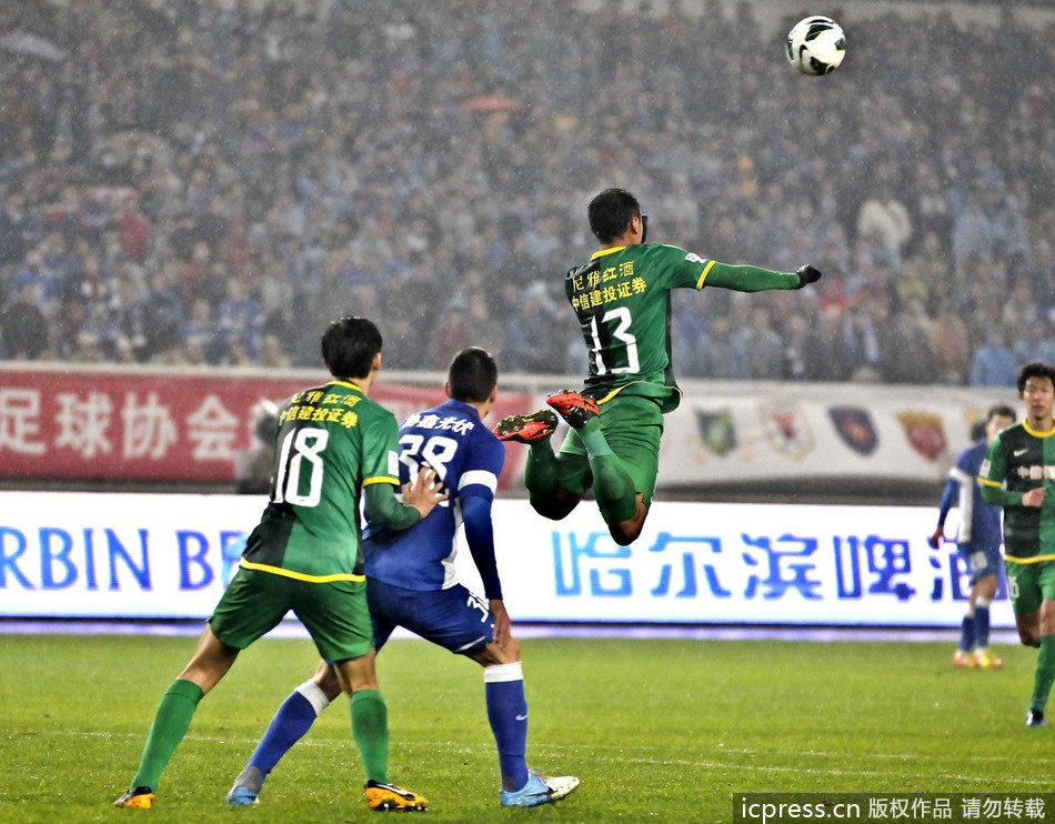 Xu Yunlong of Beijing Guoan jumps for the header. 