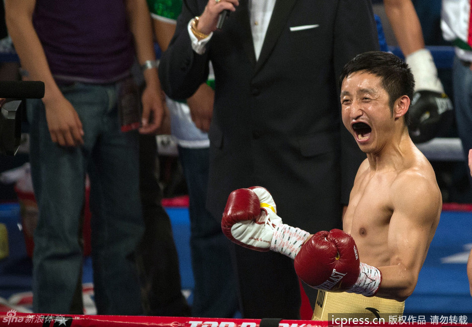 Zou Shiming celebrates winning his first professional boxing match. 