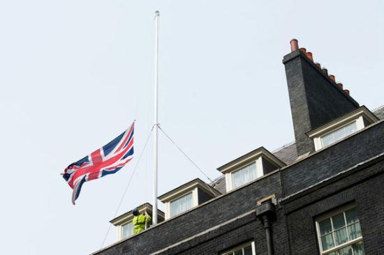 Workmen lower Britain's Union flag to half-mast above 10 Downing Street in London, on April 8, 2013, following the death of former British Prime Minister Margaret Thatcher. 