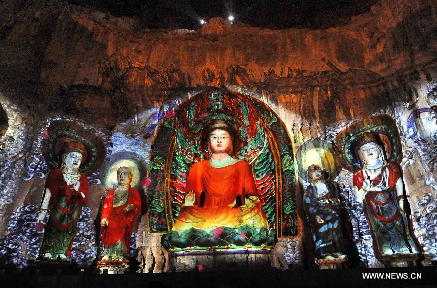 Photo taken on April 8, 2013 shows the buddhas are illuminated in scenic area of Longmen Grottoes in Luoyang, central China's Henan Province. The night tour at Longmen Grottoes, a world cultural heritage site, has been opened to public since Monday. (Xinhua/Wang Song)