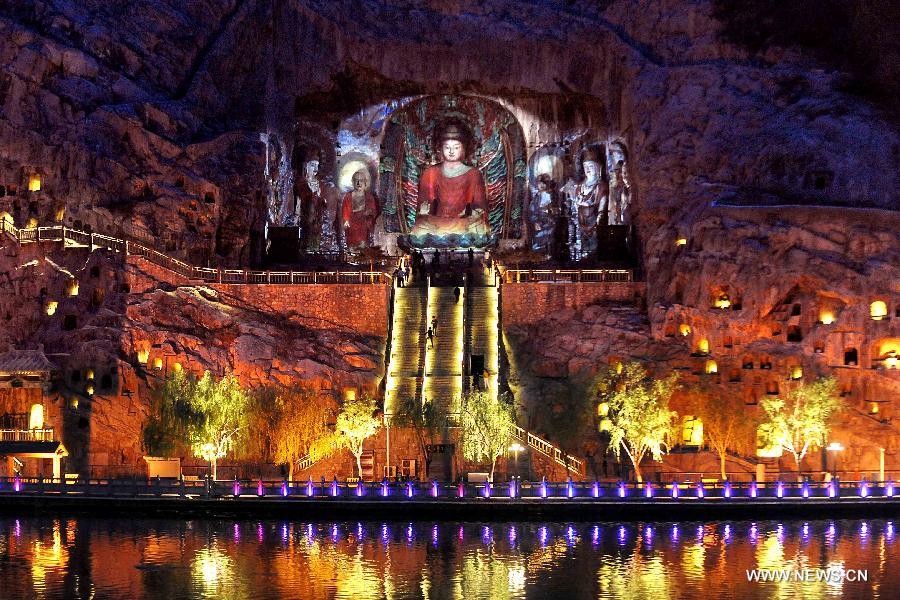 Photo taken on April 8, 2013 shows the night scenery of Fengxian Temple in scenic area of Longmen Grottoes in Luoyang, central China's Henan Province. The night tour at Longmen Grottoes, a world cultural heritage site, has been opened to public since Monday. (Xinhua/Wang Song)