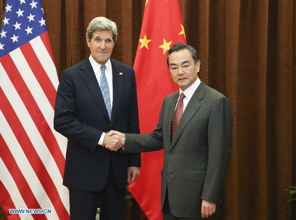 Chinese Foreign Minister Wang Yi (R) shakes hands with U.S. Secretary of State John Kerry in Beijing, capital of China, April 13, 2013. [Xinhua]