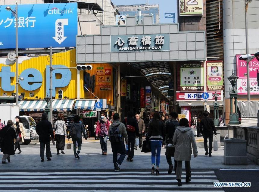 Pedestrians are seen in the Shinsaibashi-Suji Business District in west Japan&apos;s Osaka city, April 13, 2013. A powerful earthquake registering a preliminary magnitude of 6 hit Hyogo Prefecture and it surrounding areas in western Japan early Saturday morning, injuring 16 people. (Xinhua/Ma Xinghua)