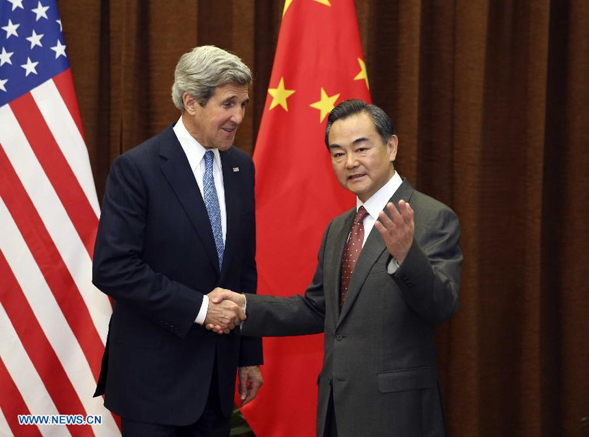 Chinese Foreign Minister Wang Yi (R) shakes hands with U.S. Secretary of State John Kerry in Beijing.