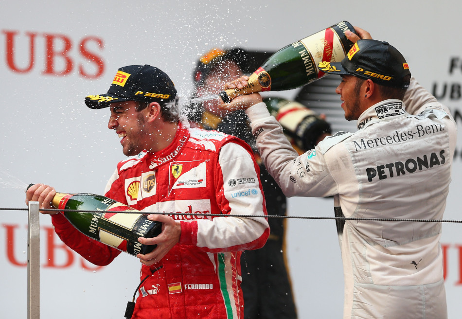 Former McLaren team-mates Hamilton and Alonso celebrate on the podium.