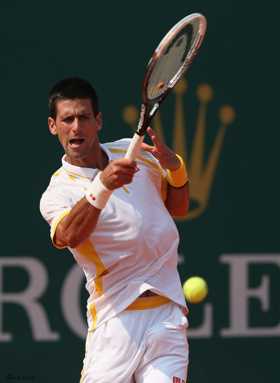 Djokovic returns a ball. 