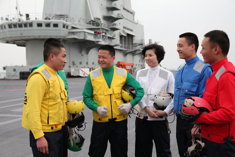 Crew members onboard China's Liaoning Aircraft Carrier communicate with each other on the dock on Thursday April 18, 2013. [Photo/CFP]