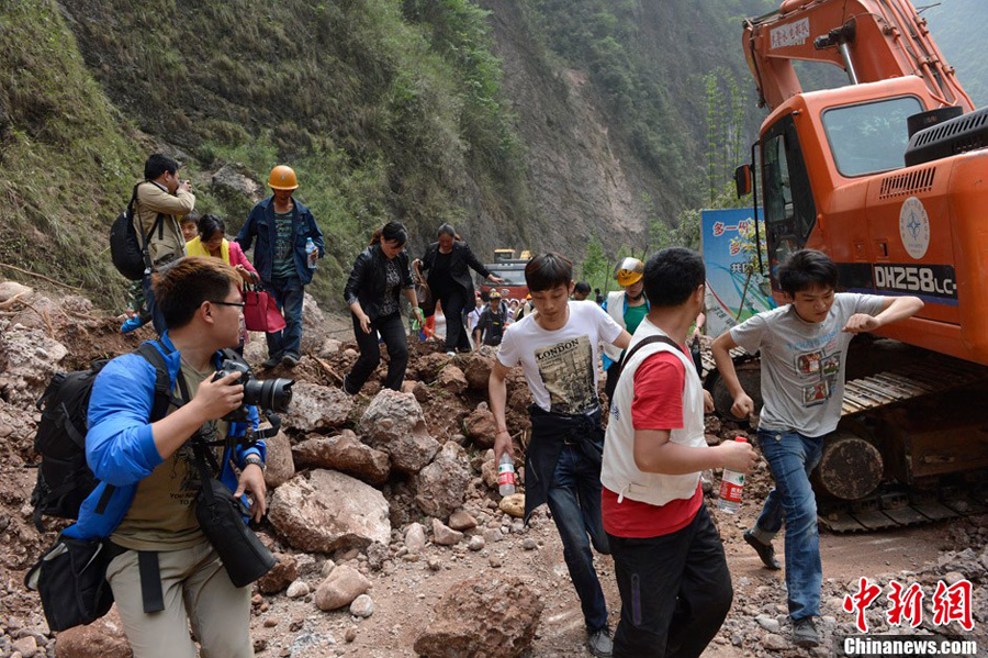 Rescuers and reporters rush to Baoxing County, an isolated county in southwest China's Sichuan Province hit by Saturday's strong earthquake, on April 21. [Chinanews.com]
