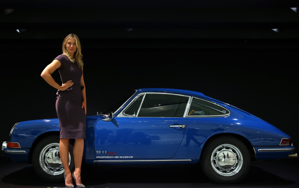 Tennis player Maria Sharapova poses next to a Porsche 911 2.0 Coupe at the Porsche Museum on April 22, 2013 in Stuttgart, Germany.