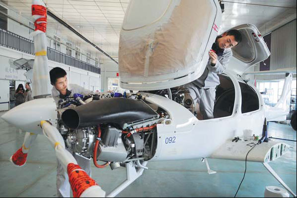 Workers assemble a plane at Shandong Bin Ao Aircraft Industries Co Ltd in Binzhou, Shandong province. The flash HSBC Purchasing Managers' Index for April fell to 50.5 from 51.6 in March, but was still stronger than February's reading of 50.4. [China Daily]