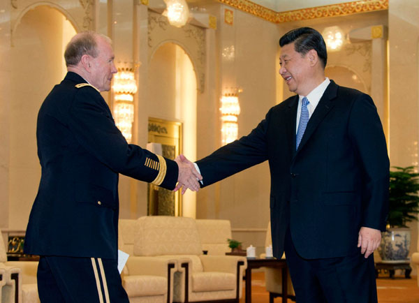 President Xi Jinping greets Chairman of the US Joint Chiefs of Staff General Martin Dempsey at the Great Hall of the People in Beijing on Tuesday. [China Daily/ Reuters]