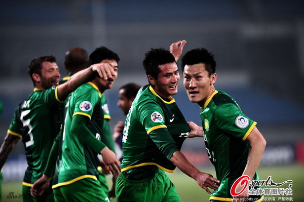 Shao Jiayi congratulated by teammates after scoring Guoan's second goal.