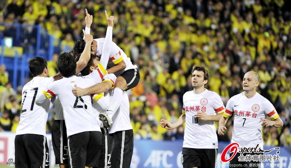 Guizhou Renhe players celebrate Li Kai's goal. 