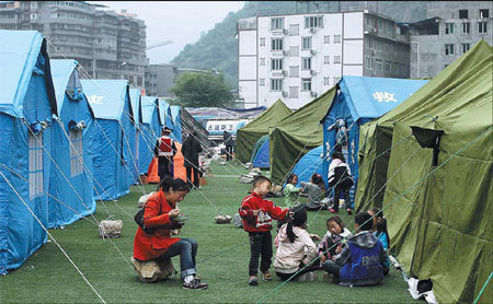 Displaced residents of Baoxing county in the tent city at the local stadium. [Photo/ China Daily]