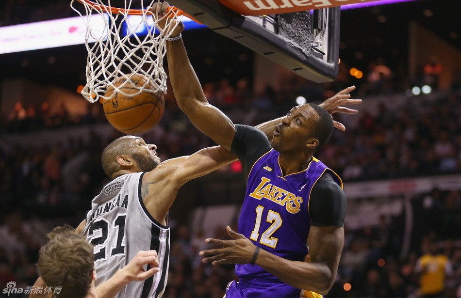 Dwight Howard slams dunk in front of Tim Duncan in Game 2 of NBA Western Conference first-round series between San Antonio Spurs and LA Lakers. 