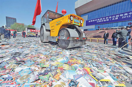 Pirated publications and CDs are destroyed in Taiyuan, capital of Shanxi province, on Thursday, to mark World Intellectual Property Day on Friday.[China Daily]