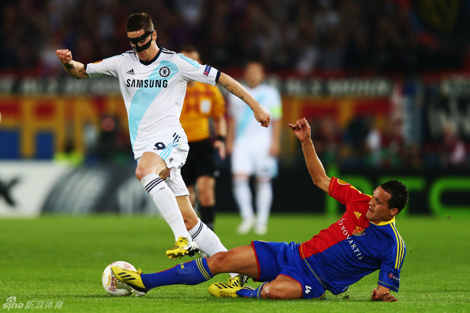 Torres tackled by defender. 