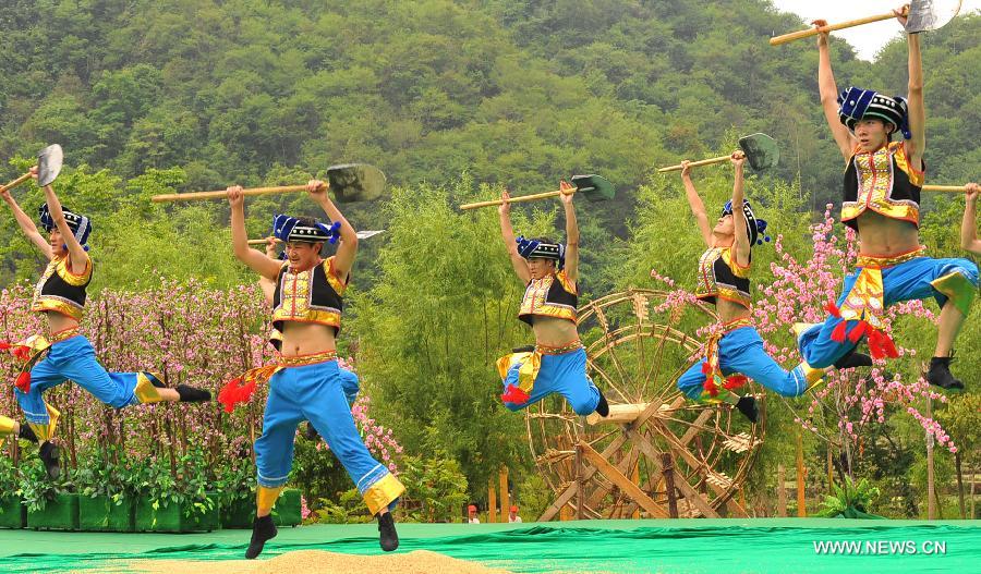 Villagers of Zhuang ethnic group stage a labor dance during a performance held for tourists in Bamei Village, Guangnan County, southwest China's Yunnan Province, April 30, 2013. The county arranged the performance in the hope of displaying local cultural and landscape, and drawing tourists during the three-day May Day holidays. (Xinhua/Chen Haining) 