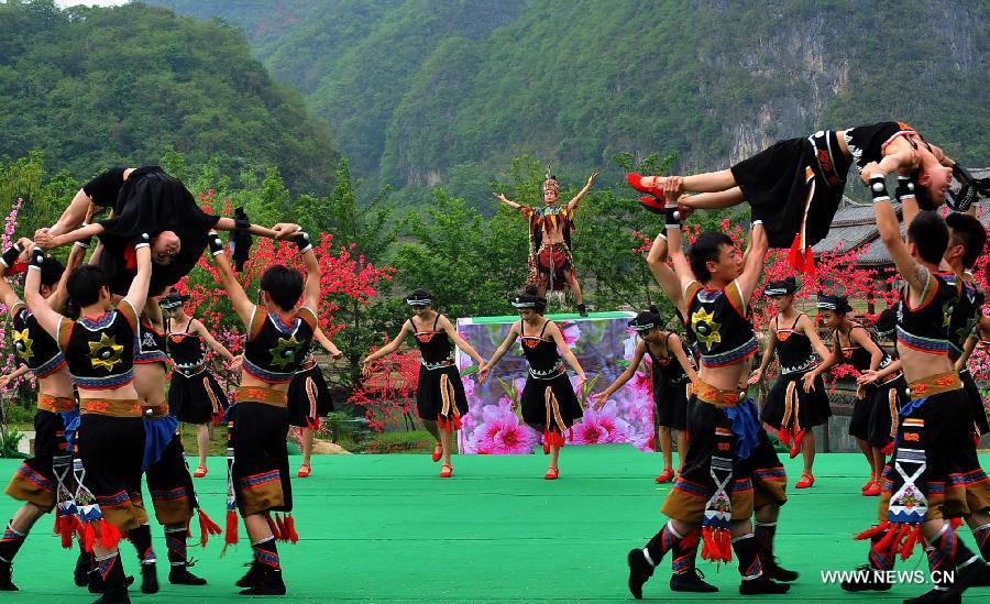 Villagers of Zhuang ethnic group stage a dance during a performance held for tourists in Bamei Village, Guangnan County, southwest China's Yunnan Province, April 30, 2013. The county arranged the performance in the hope of displaying local cultural and landscape, and drawing tourists during the three-day May Day holiday. (Xinhua/Chen Haining) 