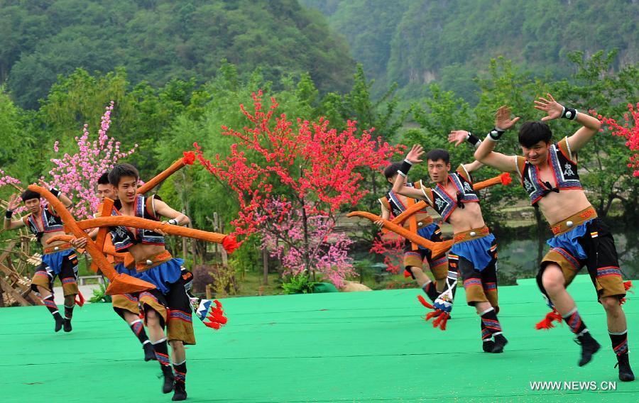 Villagers of Zhuang ethnic group stage a dance during a performance held for tourists in Bamei Village, Guangnan County, southwest China's Yunnan Province, April 30, 2013. The county arranged the performance in the hope of displaying local cultural and landscape, and drawing tourists during the three-day May Day holidays. (Xinhua/Chen Haining) 