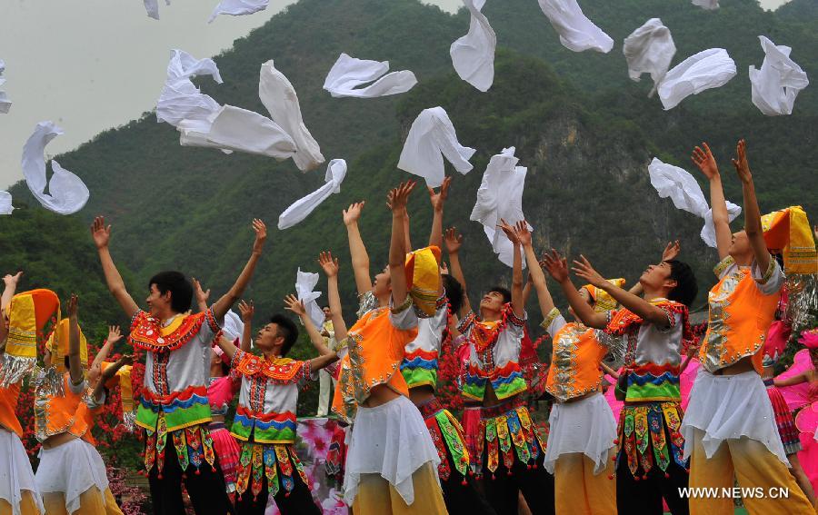 Villagers of Zhuang ethnic group stage a performance held for tourists in Bamei Village, Guangnan County, southwest China's Yunnan Province, April 30, 2013. The county arranged the performance in the hope of displaying local cultural and landscape, and drawing tourists during the three-day May Day holiday. (Xinhua/Chen Haining) 