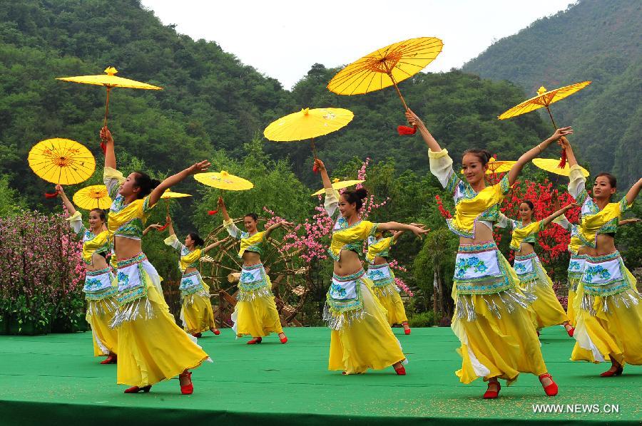 Villagers of Zhuang ethnic group stage a dance during a performance held for tourists in Bamei Village, Guangnan County, southwest China's Yunnan Province, April 30, 2013. The county arranged the performance in the hope of displaying local cultural and landscape, and drawing tourists during the three-day May Day holidays. (Xinhua/Chen Haining) 