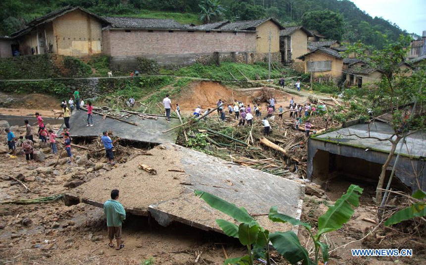 Locals clear the debris at flood-affected Juntian Village in Shuangfeng Town of Bobai County, south China&apos;s Guangxi Zhuang Autonomous Region, May 1, 2013. Floods and landslides triggered by heavy rain have claimed five lives while affecting more than 200,000 people in Guangxi. 